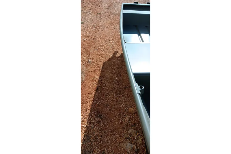 Slide: The Image of 2026 Tracker Topper 1542 LW Riveted Jon boat on gravel surface. - 3