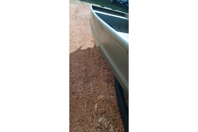 Slide: The Image of Side view of 2026 Tracker Topper 1542 LW Riveted Jon boat on gravel. - 4