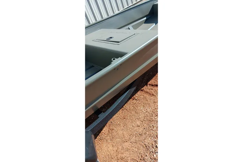 Slide: The Image of 2026 Tracker Topper 1542 LW Riveted Jon boat on gravel surface. - 7