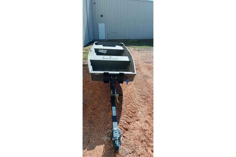 Slide: The Image of 2026 Tracker Topper 1542 LW Riveted Jon boat on trailer, parked outdoors. - 9