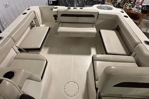 Slide: The Image of 2022 Sailfish 245 DC boat interior with beige seating and spacious layout. - 15