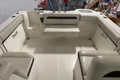 Slide: The Image of 2022 Sailfish 245 DC boat interior with seating and storage compartments. - 16