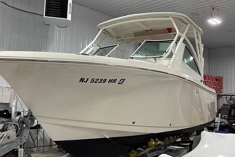 Slide: The Image of 2022 Sailfish 245 DC boat in indoor storage, showcasing sleek design and modern features. - 3