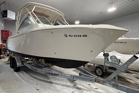 Slide: The Image of 2022 Sailfish 245 DC boat on trailer in indoor storage facility. - 4