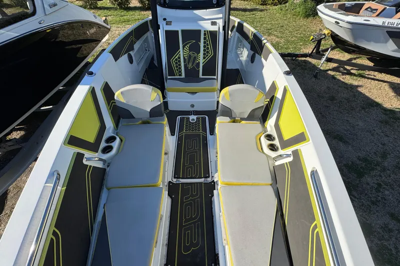 Slide: The Image of 2022 Scarab 255 Open ID boat interior with modern seating and vibrant yellow accents. - 10