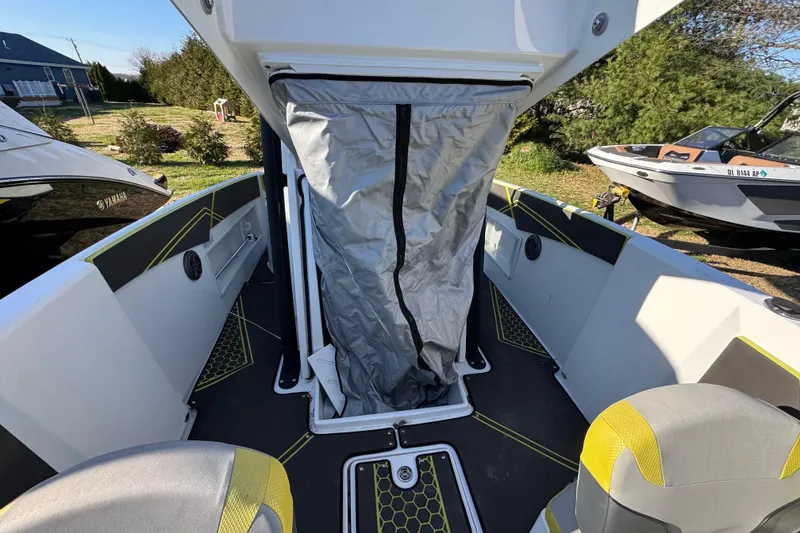 Slide: The Image of 2022 Scarab 255 Open ID boat interior with seating and storage area. - 12