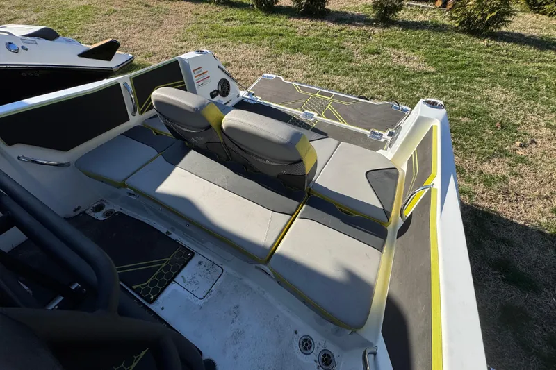 Slide: The Image of 2022 Scarab 255 Open ID boat interior with gray and yellow seating. - 14