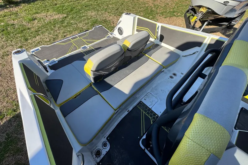 Slide: The Image of 2022 Scarab 255 Open ID boat interior with gray and yellow seating. - 6