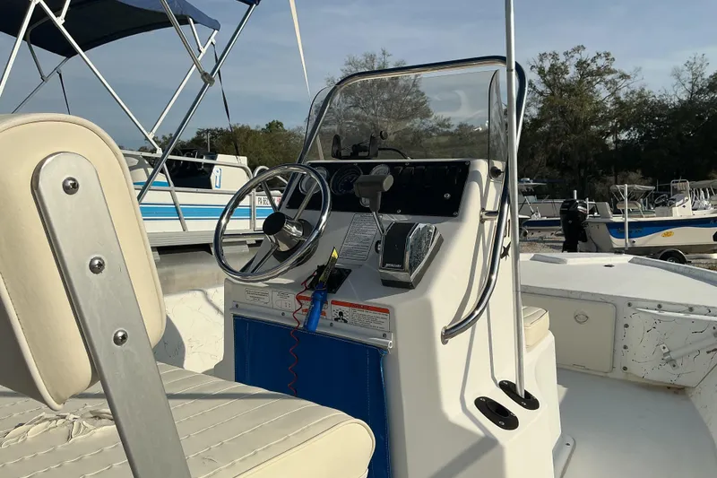 Slide: The Image of 2010 Mako 181 Inshore boat console with steering wheel and controls. - 4