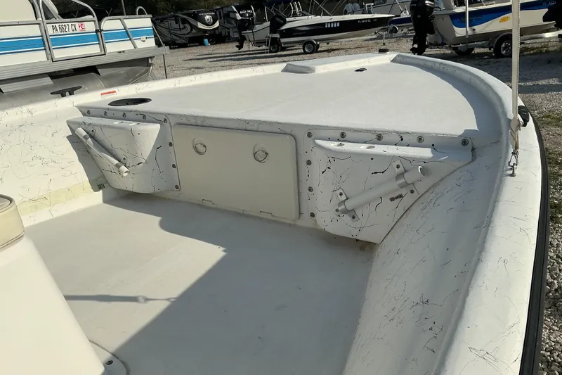 Slide: The Image of 2010 Mako 181 Inshore boat deck with storage compartments and rod holders. - 7