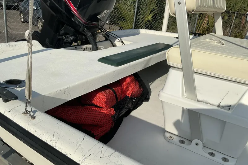 Slide: The Image of 2010 Mako 181 Inshore boat interior with storage compartment and seating. - 8