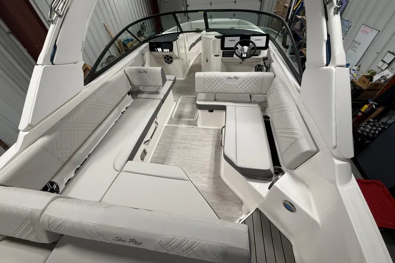 Slide: The Image of 2026 Sea Ray SDX 270 boat interior with spacious seating and modern dashboard. - 10