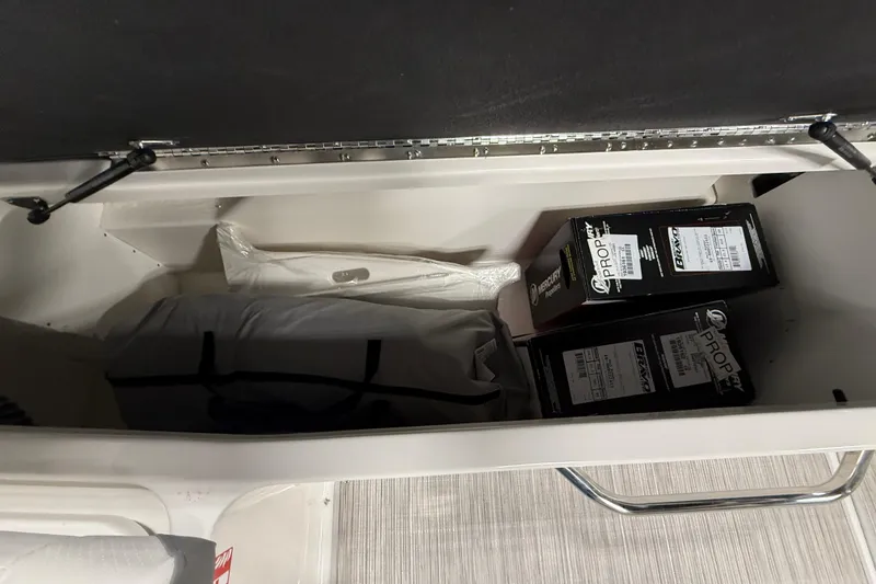 Slide: The Image of Storage compartment in a 2026 Sea Ray SDX 270 boat with propeller boxes. - 14