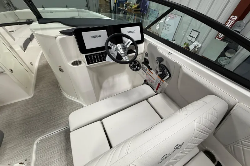 Slide: The Image of 2026 Sea Ray SDX 270 boat interior with Simrad navigation system and luxurious seating. - 18