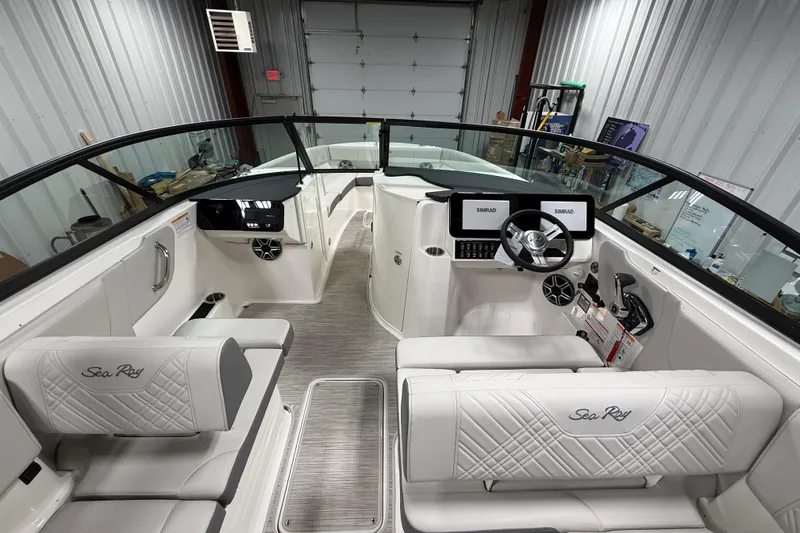 Slide: The Image of 2026 Sea Ray SDX 270 boat interior with modern dashboard and luxurious seating. - 19