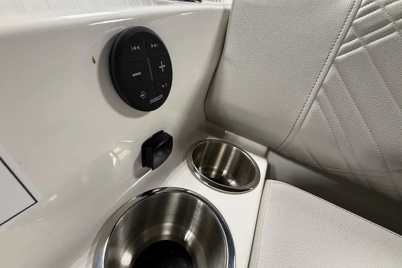Slide: The Image of 2026 Sea Ray SDX 270 boat interior with Fusion audio controls and stainless steel cup holders. - 29