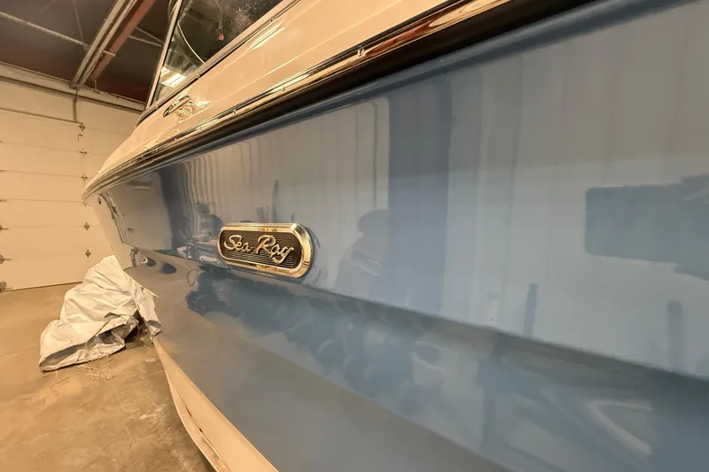 Slide: The Image of 2026 Sea Ray SDX 270 boat in a garage, showcasing sleek blue exterior. - 30