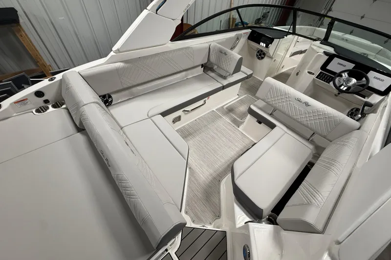 Slide: The Image of 2026 Sea Ray SDX 270 boat interior with luxurious seating and modern dashboard. - 9