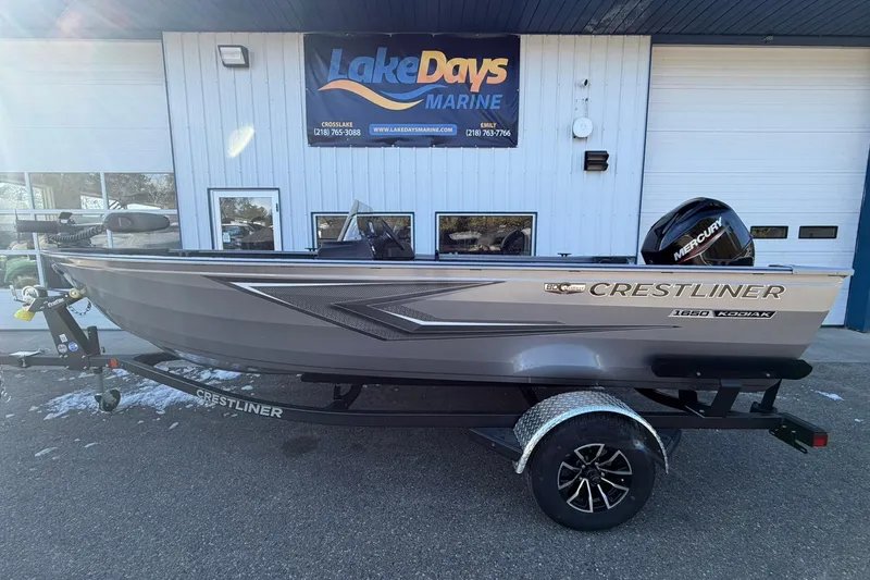 The Image of 2026 Crestliner 1650 Kodiak boat on trailer outside Lake Days Marine. - 1