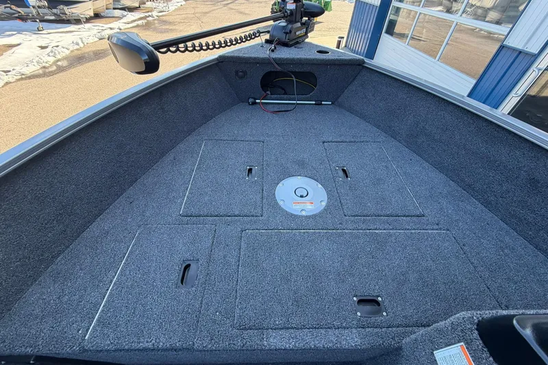 Slide: The Image of 2026 Crestliner 1650 Kodiak boat deck with storage compartments and trolling motor. - 10