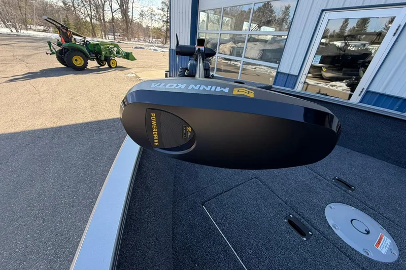 Slide: The Image of 2026 Crestliner 1650 Kodiak boat with Minn Kota PowerDrive motor in a parking lot. - 11