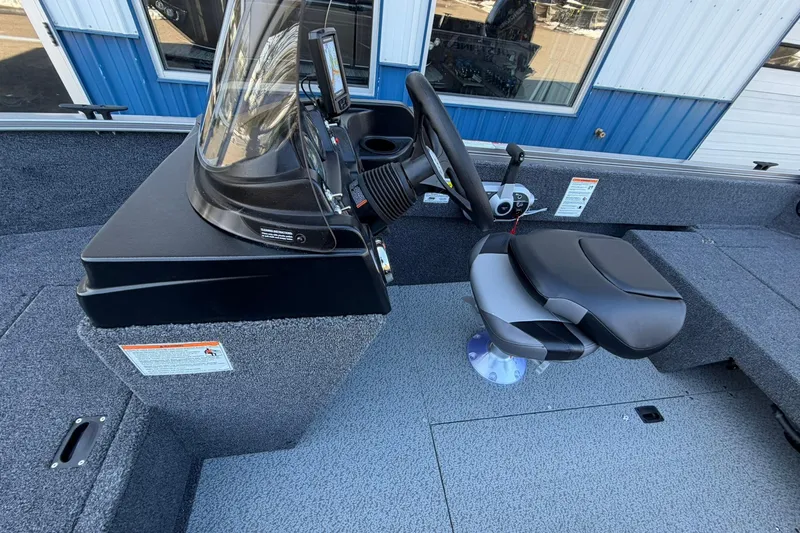 Slide: The Image of 2026 Crestliner 1650 Kodiak boat interior with steering console and seating. - 12