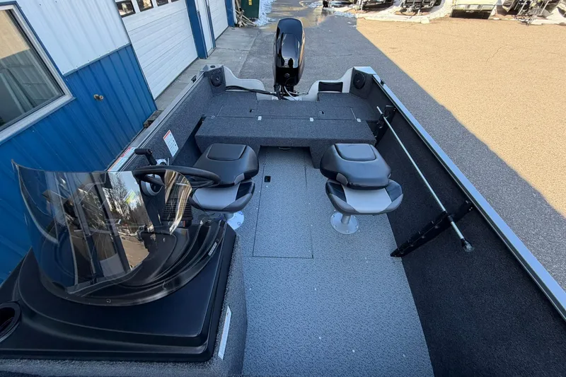 Slide: The Image of 2026 Crestliner 1650 Kodiak boat interior with seating and steering console. - 14
