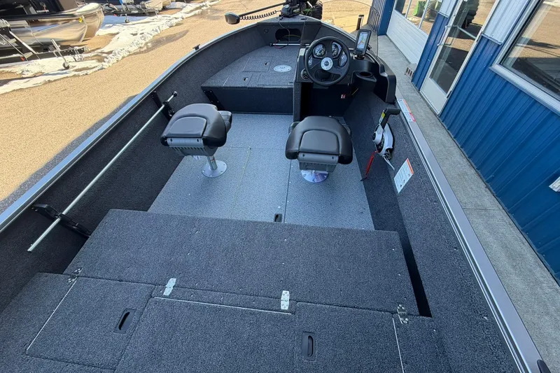 Slide: The Image of 2026 Crestliner 1650 Kodiak fishing boat interior with dual seats and steering console. - 7