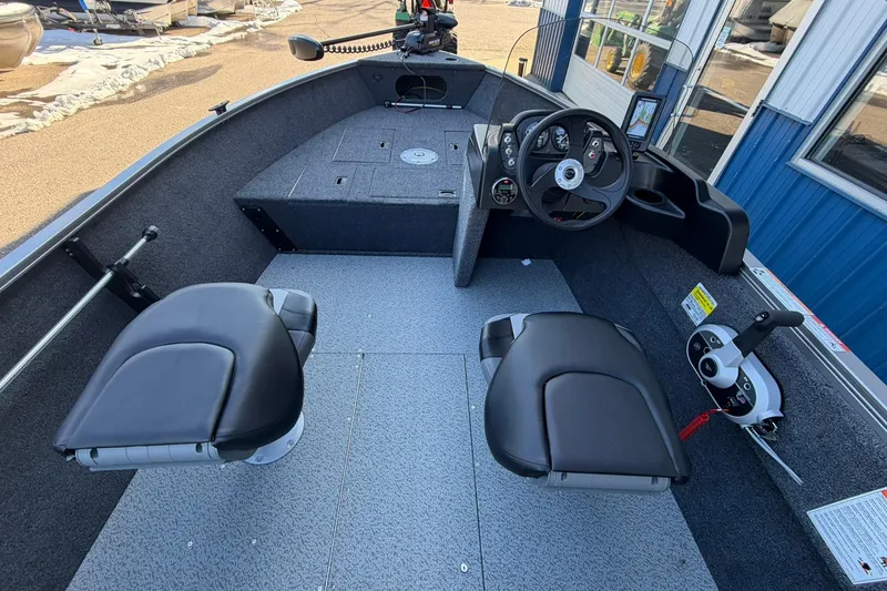 Slide: The Image of 2026 Crestliner 1650 Kodiak boat interior with steering console and seating. - 8