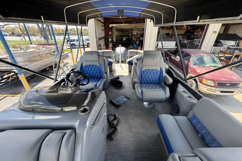 Slide: The Image of 2020 Bennington R 25 RFB pontoon boat interior with blue and gray seating. - 11