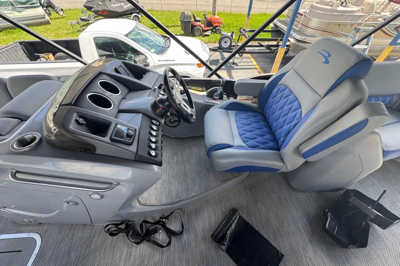 Slide: The Image of 2020 Bennington R 25 RFB boat interior with steering console and luxurious captain's chair. - 12