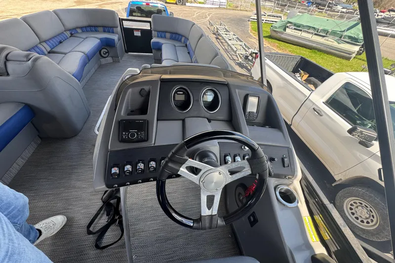 Slide: The Image of 2020 Bennington R 25 RFB boat interior with steering wheel and seating area. - 13