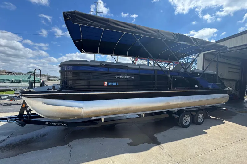 Slide: The Image of 2020 Bennington R 25 RFB pontoon boat on trailer under blue sky. - 5