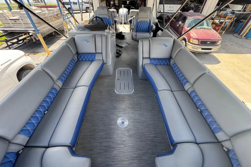 Slide: The Image of 2020 Bennington R 25 RFB pontoon boat interior with gray and blue seating. - 7