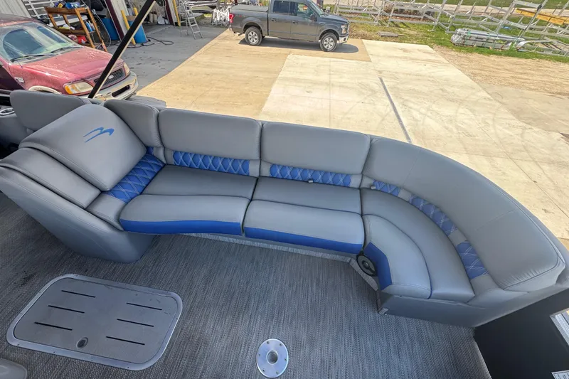 Slide: The Image of 2020 Bennington R 25 RFB boat interior with gray and blue seating. - 9