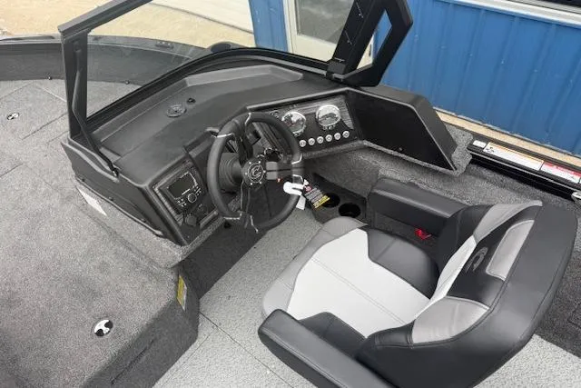Slide: The Image of 2026 Crestliner 2050 Fish Hawk boat interior with steering wheel and dashboard controls. - 14
