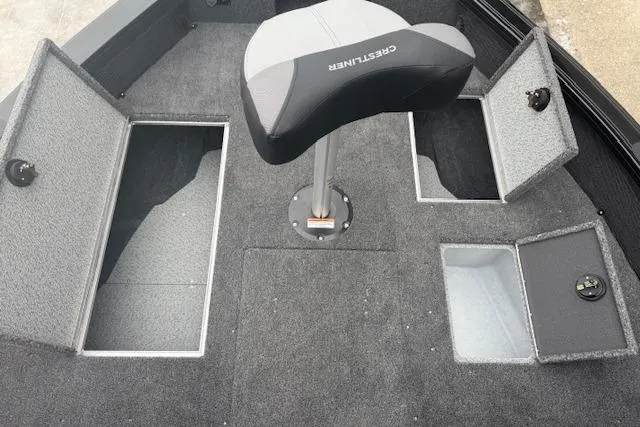 Slide: The Image of 2026 Crestliner 2050 Fish Hawk boat interior with storage compartments and seat. - 15