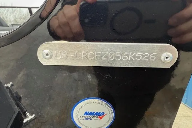 Slide: The Image of 2026 Crestliner 2050 Fish Hawk boat with visible hull identification number and NMMA certification sticker. - 16