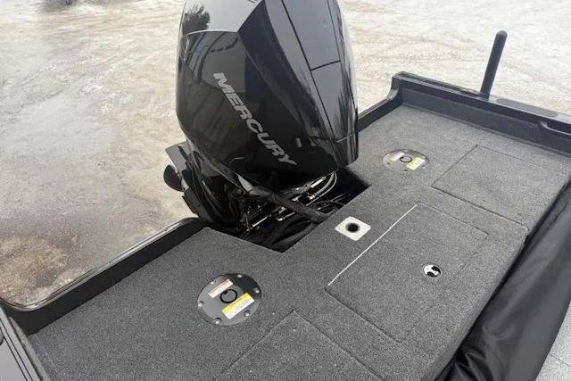 Slide: The Image of 2026 Crestliner 2050 Fish Hawk boat with Mercury outboard motor on a textured deck. - 21