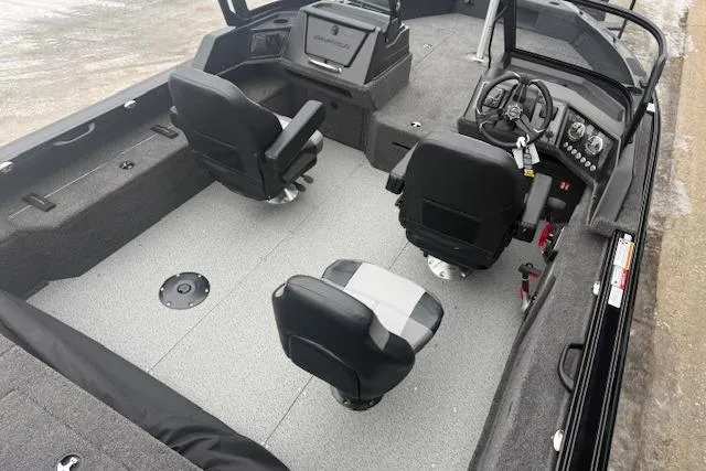 Slide: The Image of 2026 Crestliner 2050 Fish Hawk interior with three swivel seats and modern dashboard. - 9