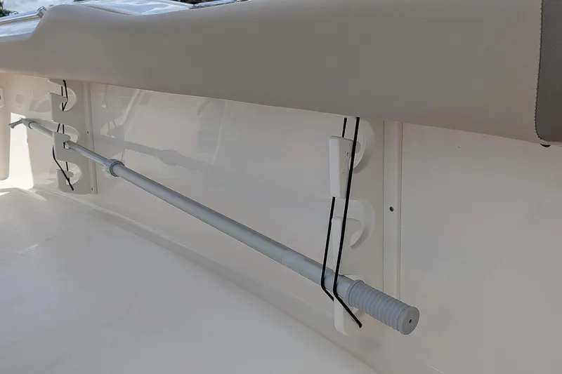 Slide: The Image of 2022 Key West 219 FS boat interior detail with rod holder and cushioned side panel. - 10