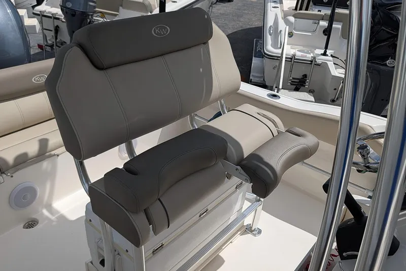 Slide: The Image of 2022 Key West 219 FS boat interior with cushioned seating and steering console. - 11