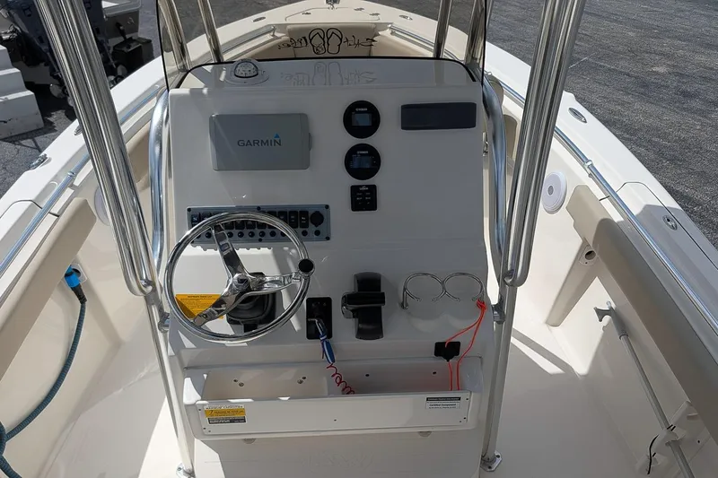 Slide: The Image of 2022 Key West 219 FS boat console with Garmin navigation system and steering wheel. - 12