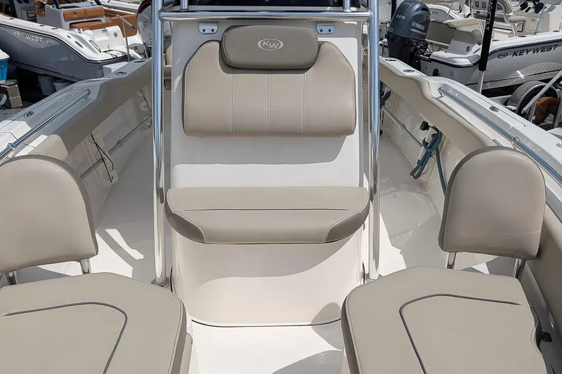 Slide: The Image of 2022 Key West 219 FS boat interior with beige seating and console. - 14