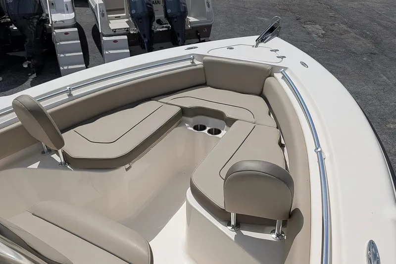Slide: The Image of 2022 Key West 219 FS boat interior with beige seating and cup holders. - 15