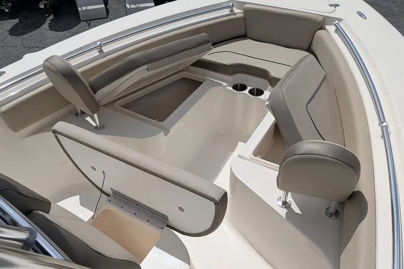 Slide: The Image of 2022 Key West 219 FS boat interior with cushioned seating and cup holders. - 16