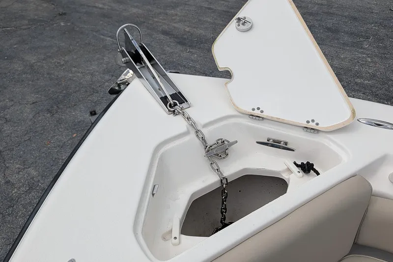 Slide: The Image of 2022 Key West 219 FS boat anchor compartment with open hatch and chain. - 18