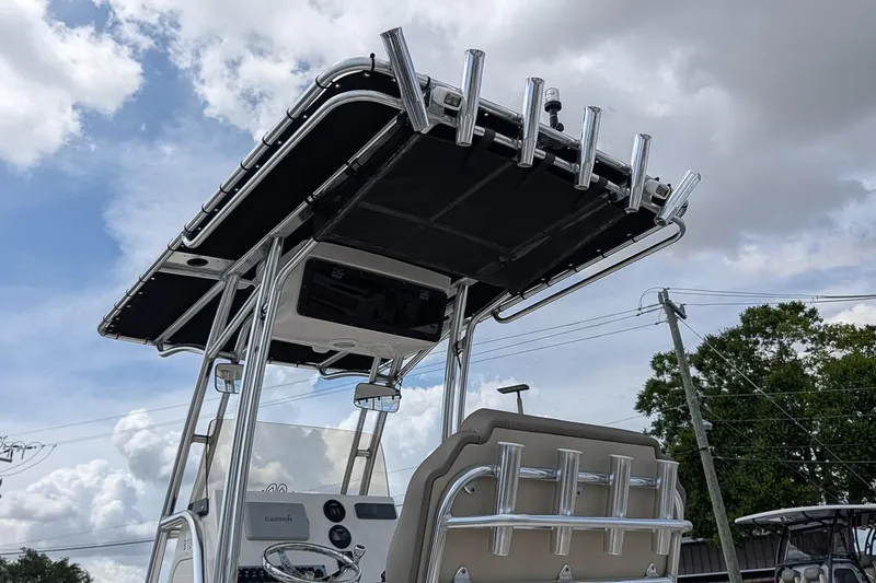 Slide: The Image of 2022 Key West 219 FS boat with T-top and rod holders under cloudy sky. - 19
