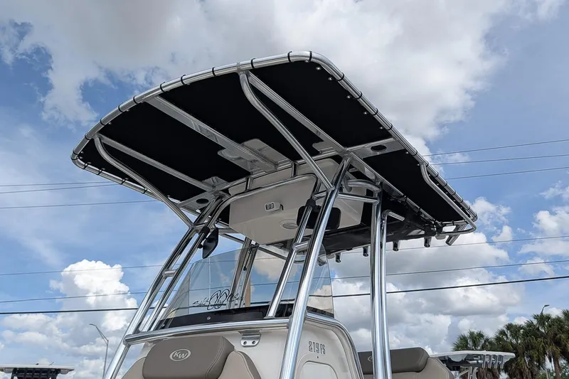 Slide: The Image of 2022 Key West 219 FS boat with T-top against a cloudy sky background. - 20
