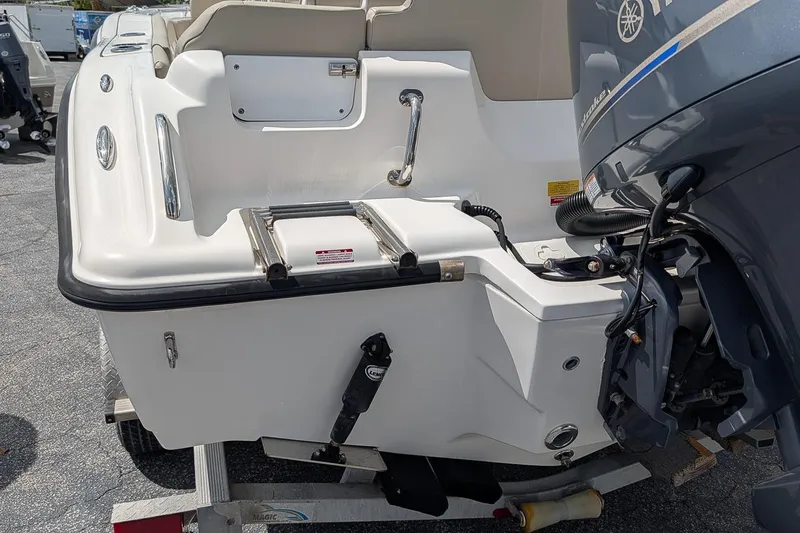 Slide: The Image of 2022 Key West 219 FS boat stern with ladder and Yamaha outboard motor. - 5